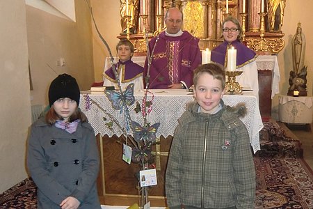 Die beiden Erstkommunionkinder Michelle Breiteneder und Paul Scheidl mit den Ministranten und P. Daniel Gärtner.