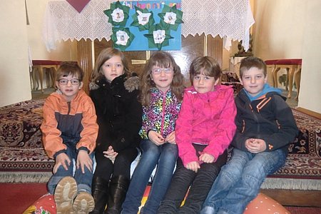 Die Erstkommunionkinder aus der Pfarre Sallingstadt:Marcel Maier aus Windhof, Lena Poppinger aus Sallingstadt, Marie Scheidl aus Walterschlag, Alexia Artmann aus Sallingstadt und Benedikt Holzmüller aus Limbach.Im Vordergrund ist das dargestellte Boot der Jünger und im Hintergrund das Plakat "Aufblühen mit Jesus" zu sehen.