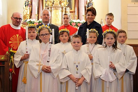 Die Erstkommunionkinder Tanja Müllner, Julia Poppinger, Petra Müllner, Dominic Bichl, Hannah Grassinger, Katharina Kletzl und Jakob Hipp gemeinsam mit Pfarrmoderator Daniel Gärtner, Direktor Ludwig Koller, Maximilian Maierhofer, Klassenlehrerin Heidi Stangl und Oliver Wagner